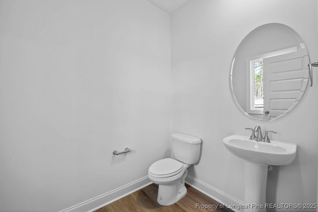 1004 Rhum Drive Fayetteville, NC 28311 - Photo 5 of 34 a bathroom with a sink toilet and a mirror