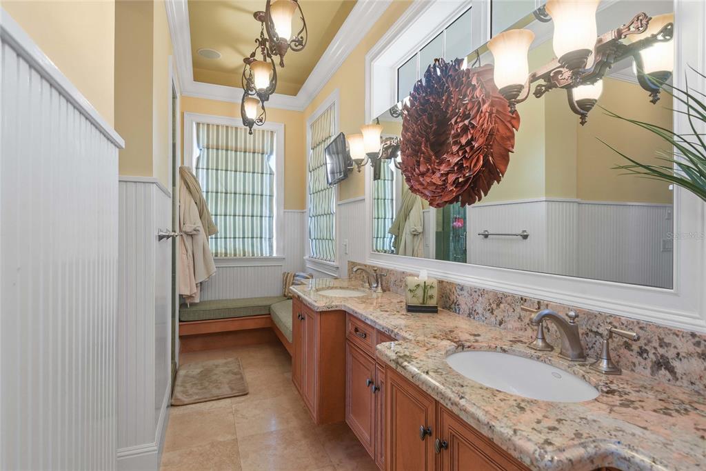 56230 Redbud Road Astor, FL 32102 - Photo 11 of 44 a bathroom with a granite countertop sink a mirror and a shower