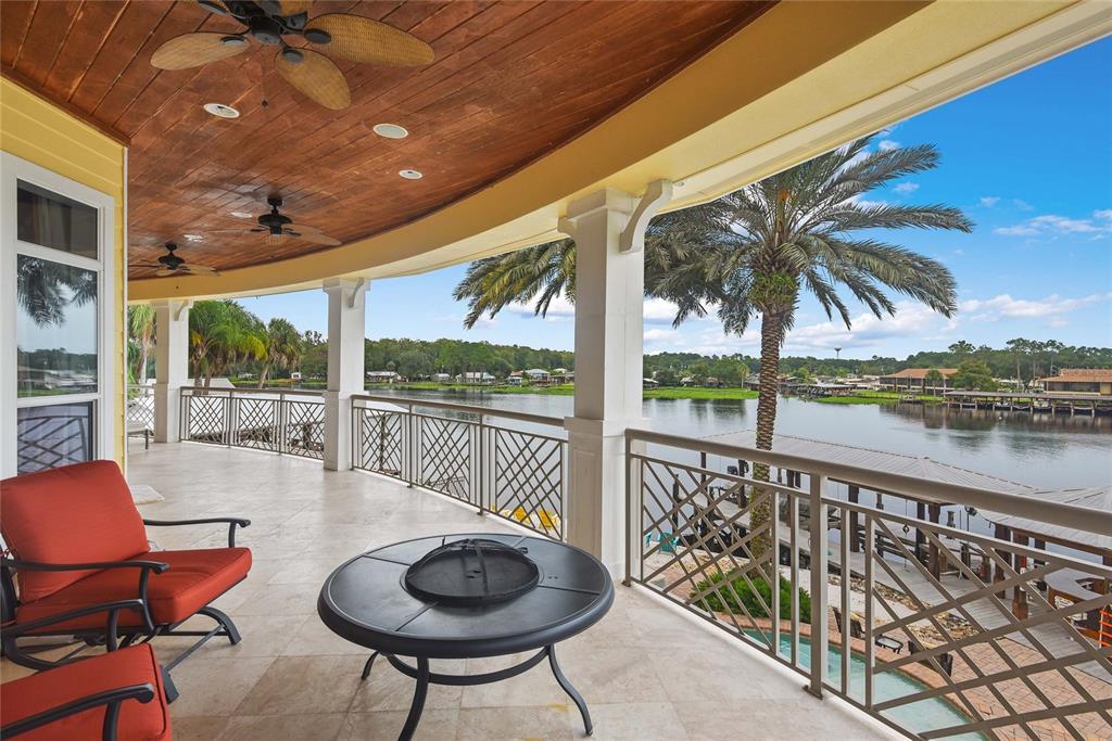 56230 Redbud Road Astor, FL 32102 - Photo 13 of 44 a balcony with table and chairs