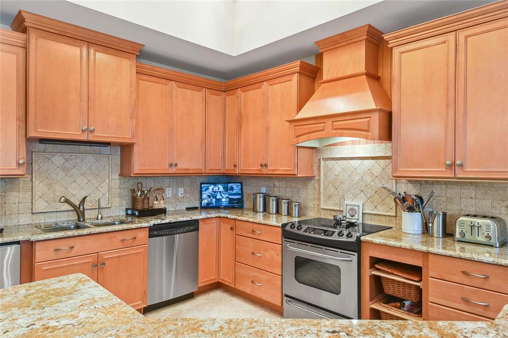56230 Redbud Road Astor, FL 32102 - Photo 18 of 44 a kitchen with stainless steel appliances granite countertop a sink a stove and a refrigerator