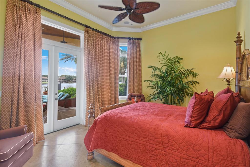 56230 Redbud Road Astor, FL 32102 - Photo 20 of 44 a bedroom with a bed and a large ceiling fan