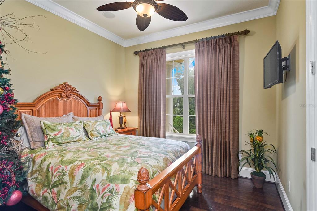 56230 Redbud Road Astor, FL 32102 - Photo 22 of 44 a bedroom with a bed and a potted plant