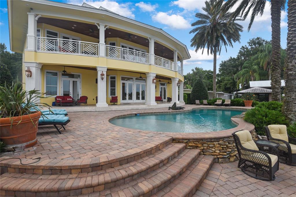 56230 Redbud Road Astor, FL 32102 - Photo 27 of 44 a view of a house with swimming pool and sitting area