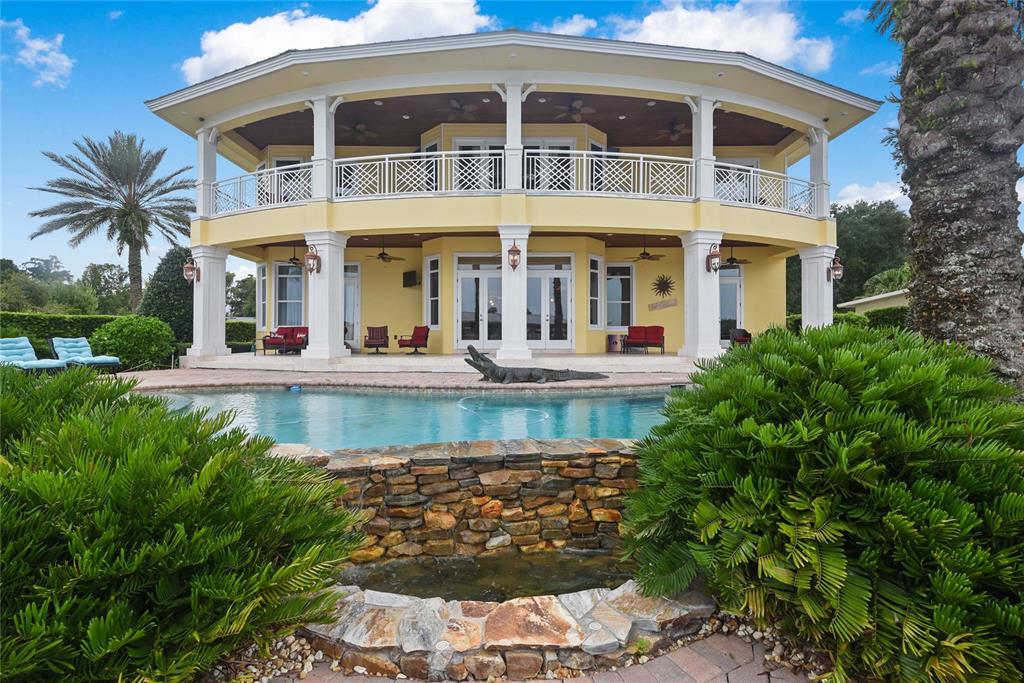 56230 Redbud Road Astor, FL 32102 - Photo 28 of 44 a front view of a building with a garden and plants