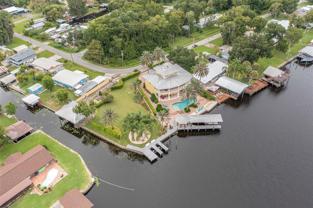 56230 Redbud Road Astor, FL 32102 - Photo 34 of 44 an aerial view of a house with a garden and lake view