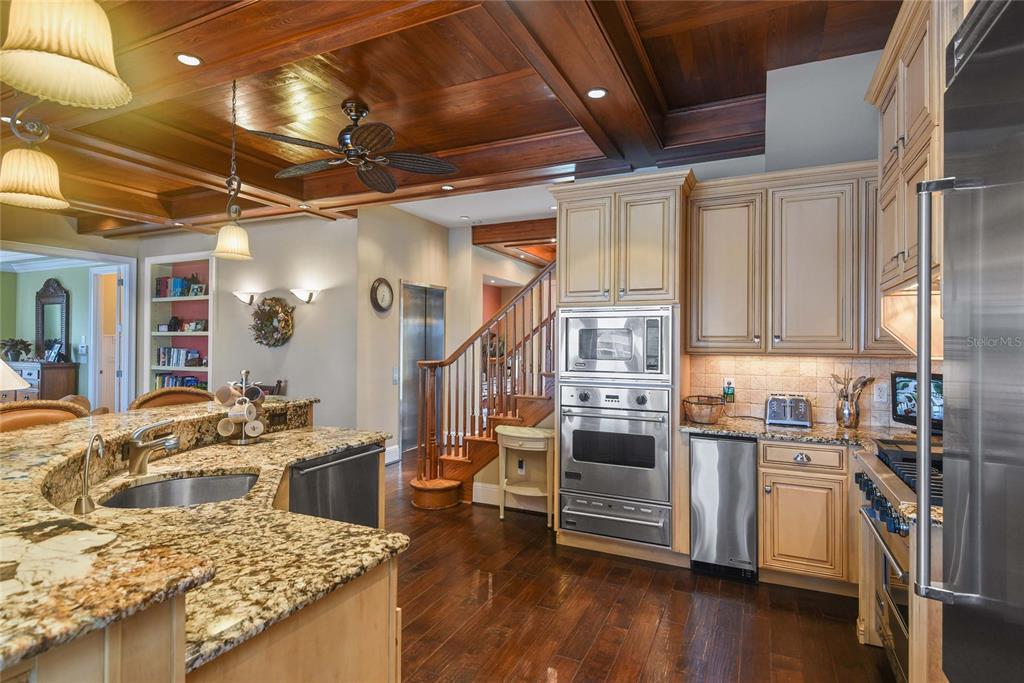 56230 Redbud Road Astor, FL 32102 - Photo 6 of 44 a kitchen with stainless steel appliances granite countertop a sink stove and wooden floor