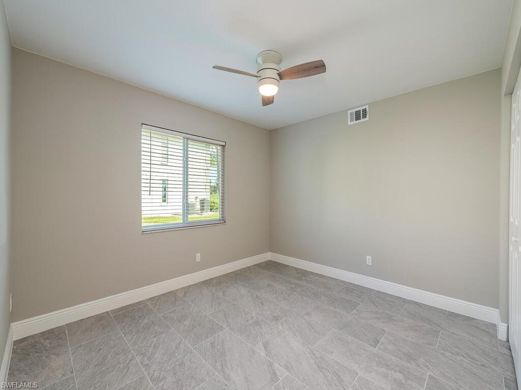 760 Augusta Boulevard, Unit D101 Naples, FL 34113 - Photo 11 of 13 an empty room with a window