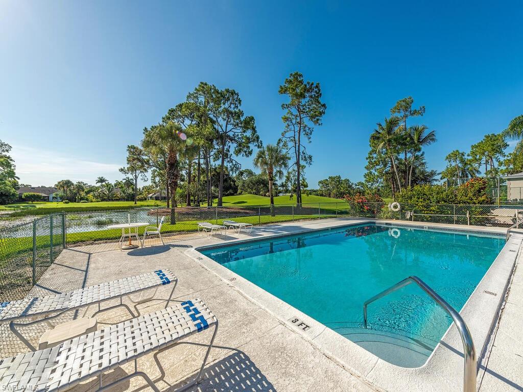 760 Augusta Boulevard, Unit D101 Naples, FL 34113 - Photo 13 of 13 swimming pool with outdoor seating and garden
