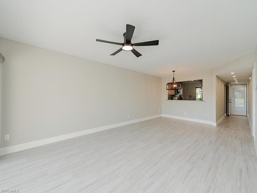 760 Augusta Boulevard, Unit D101 Naples, FL 34113 - Photo 6 of 13 wooden floor in an empty room