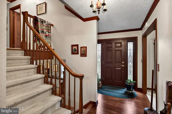 a kitchen with a refrigerator a stove a sink dishwasher and a dining table with garden view