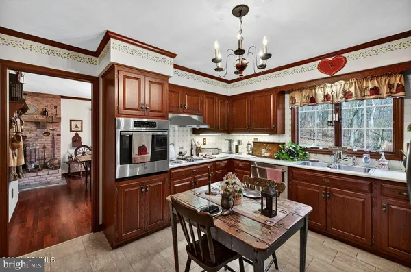 a kitchen with stainless steel appliances granite countertop a refrigerator and a stove