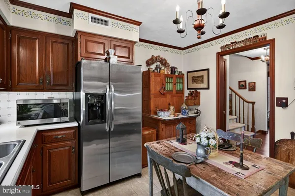 a living room with furniture a chandelier and a flat screen tv