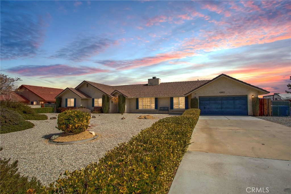 13997 Havasu Road Apple Valley, CA 92307 - Photo 1 of 1 a front view of a house with a yard