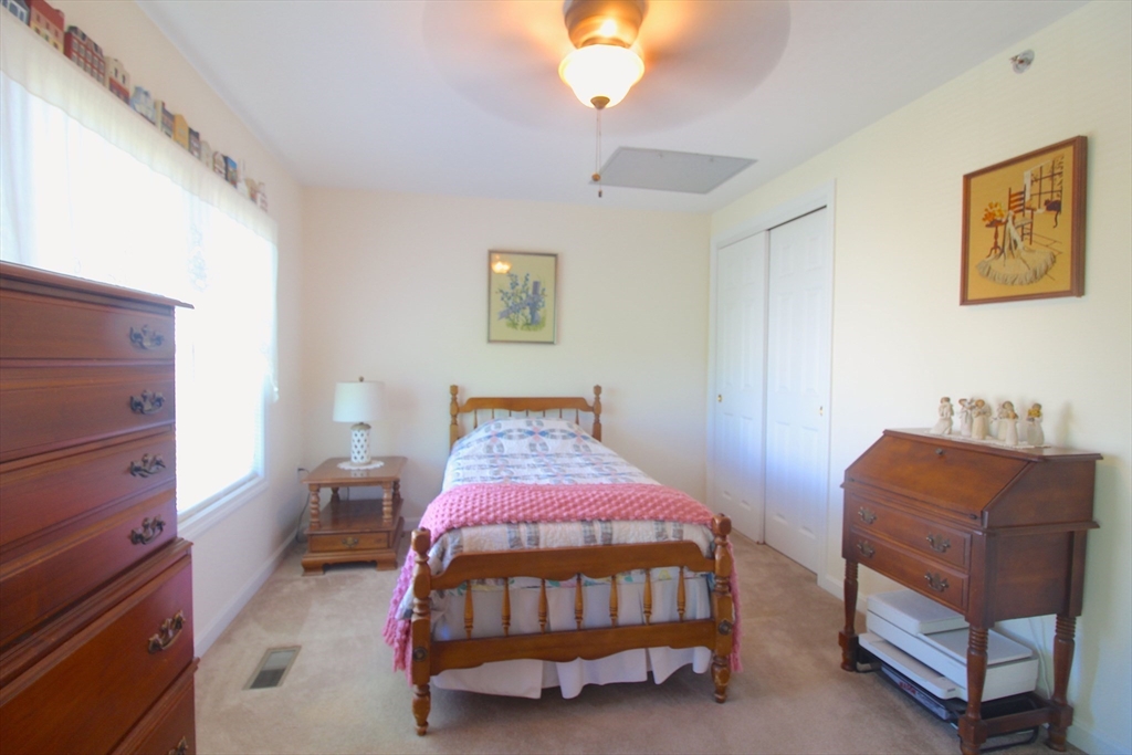 41 Boston Road, Unit 171 Billerica, MA 01862 - Photo 7 of 15 a bedroom with a bed and a couch