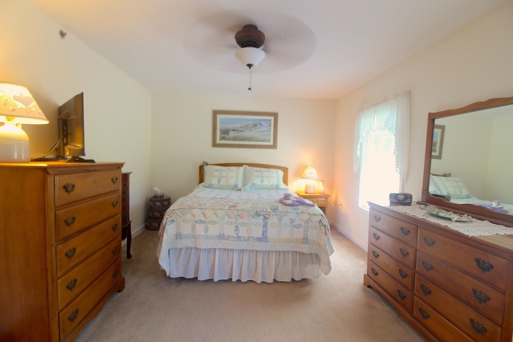 41 Boston Road, Unit 171 Billerica, MA 01862 - Photo 8 of 15 a bedroom with a bed and a flat screen tv