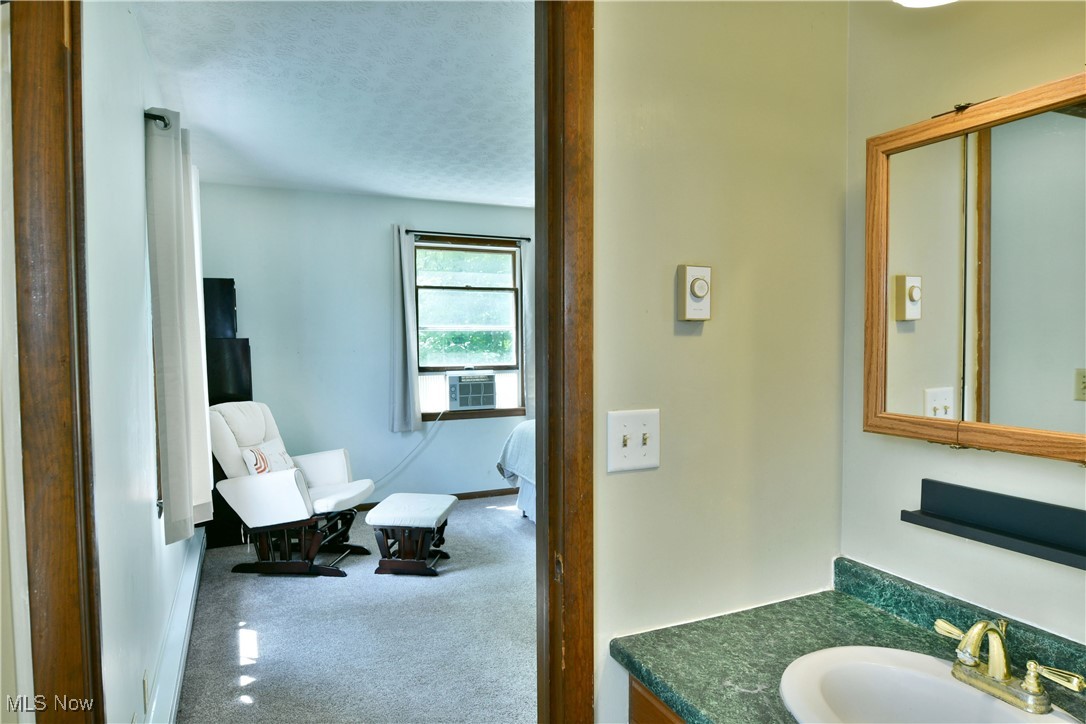 5531 Phillips Rice Road Cortland, OH 44410 - Photo 45 of 50 Bathroom featuring vanity, a textured ceiling, and cooling unit