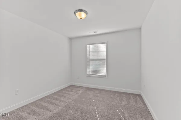 a view of a hallway with wooden floor and entryway