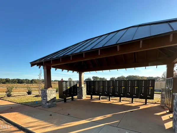 a view of a swimming pool with lawn chairs under an umbrella