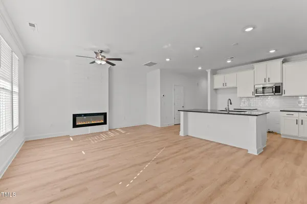a view of a kitchen with microwave and cabinets