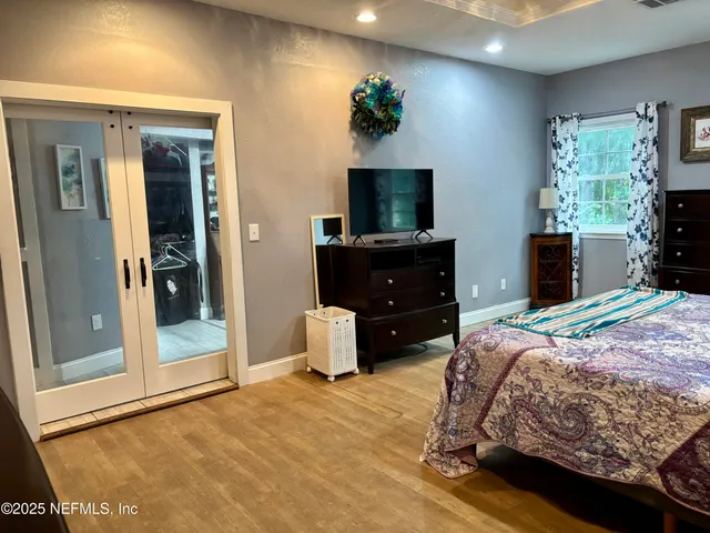 a bedroom with a bed and a flat screen television