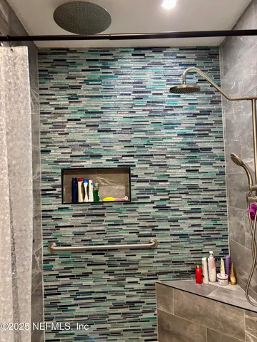 a bathroom with a shower and a sink