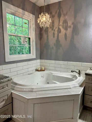 a bathroom with a sink and a white cabinet