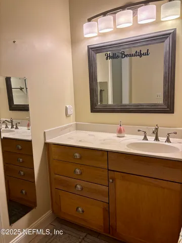 a bathroom with a sink a vanity and a mirror