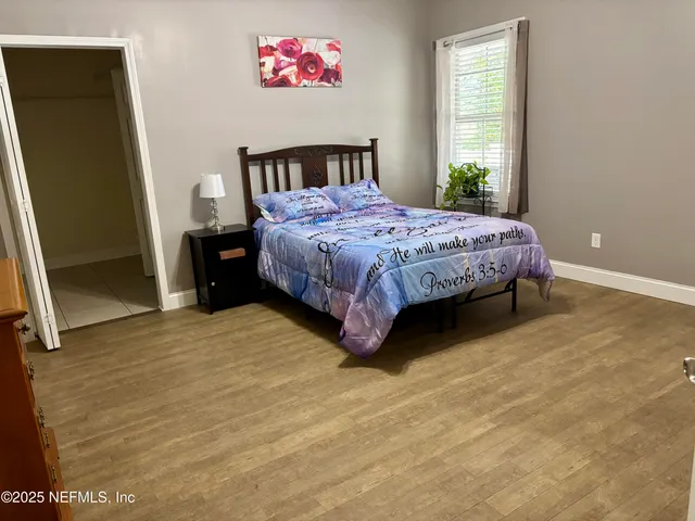 a bedroom with a bed and a window