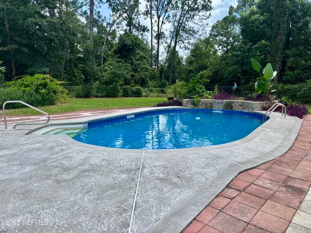 a view of swimming pool with seating space