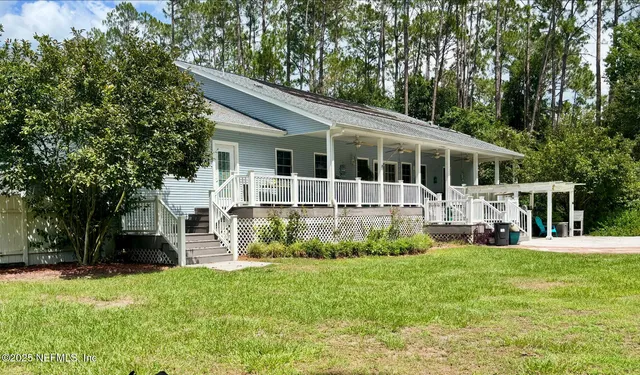 a view of a house with a yard and sitting area