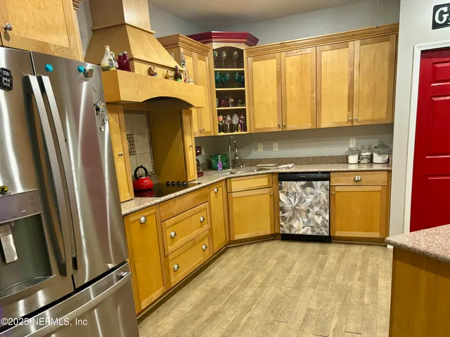 a view of a kitchen with a sink a refrigerator and window
