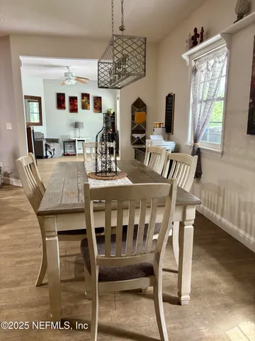 a view of a dining room with furniture and window