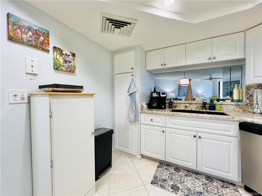 9500 South Ocean Drive, Unit 809 Jensen Beach, FL 34957 - Photo 12 of 64 a kitchen with stainless steel appliances granite countertop a refrigerator and a sink