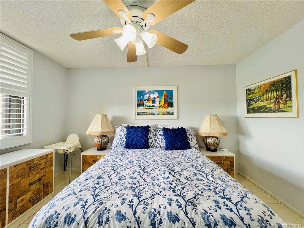 9500 South Ocean Drive, Unit 809 Jensen Beach, FL 34957 - Photo 22 of 64 a bedroom with a large bed and a chandelier