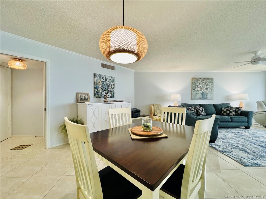 9500 South Ocean Drive, Unit 809 Jensen Beach, FL 34957 - Photo 26 of 64 a view of a dining room and hall with furniture