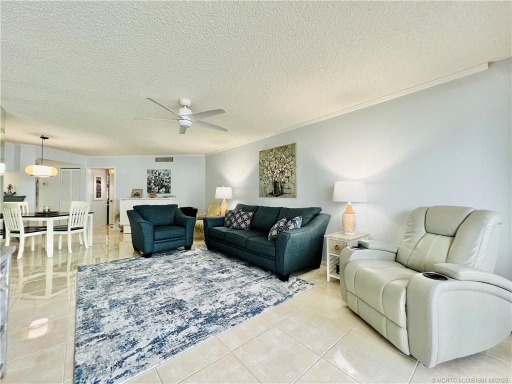 9500 South Ocean Drive, Unit 809 Jensen Beach, FL 34957 - Photo 33 of 64 a living room with furniture a fireplace and a flat screen tv