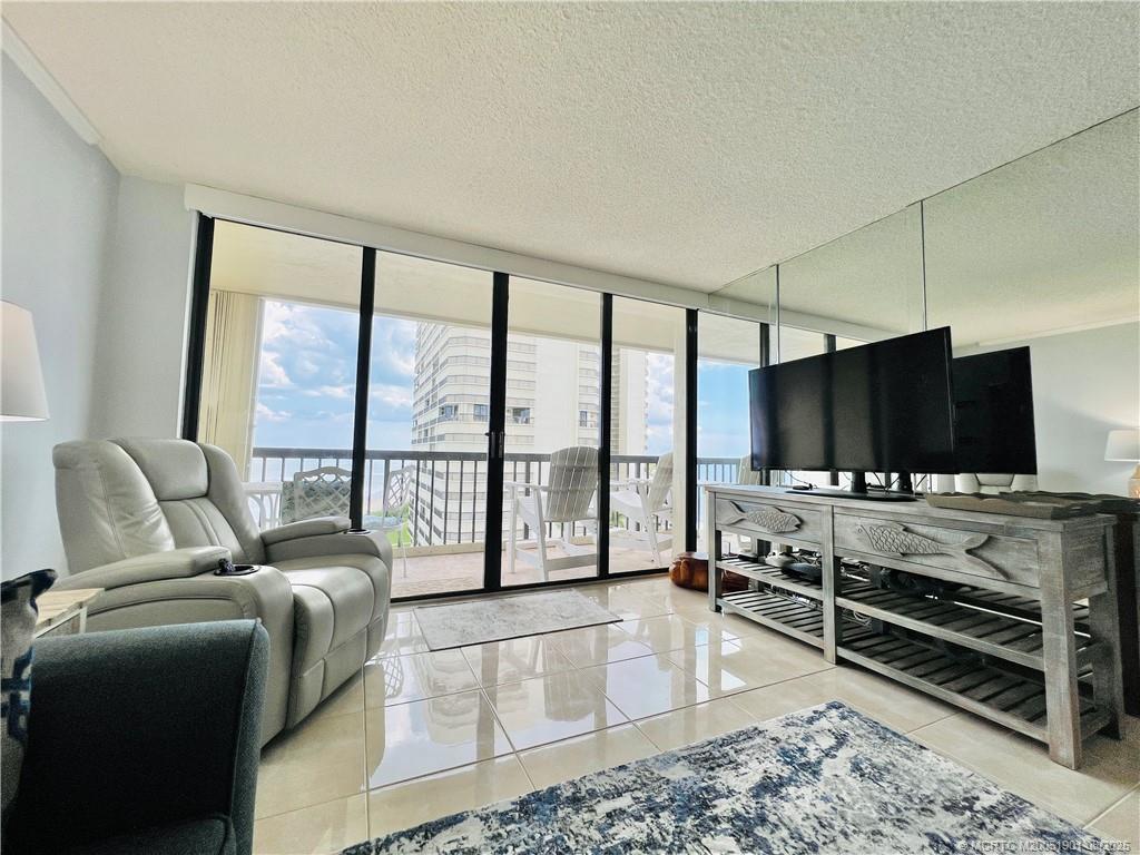 9500 South Ocean Drive, Unit 809 Jensen Beach, FL 34957 - Photo 34 of 64 a living room with furniture and a flat screen tv