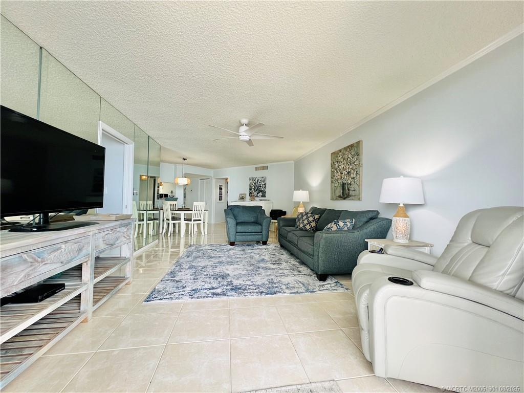 9500 South Ocean Drive, Unit 809 Jensen Beach, FL 34957 - Photo 37 of 64 a living room with furniture and a flat screen tv