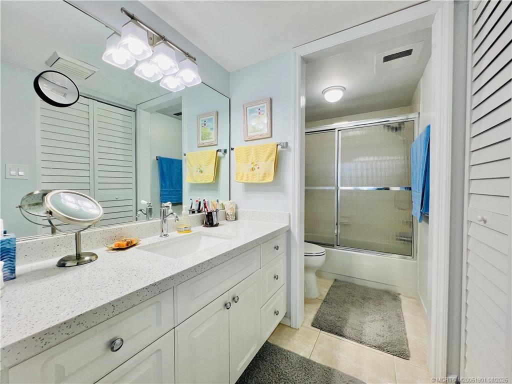 9500 South Ocean Drive, Unit 809 Jensen Beach, FL 34957 - Photo 52 of 64 a bathroom with a sink a toilet and shower