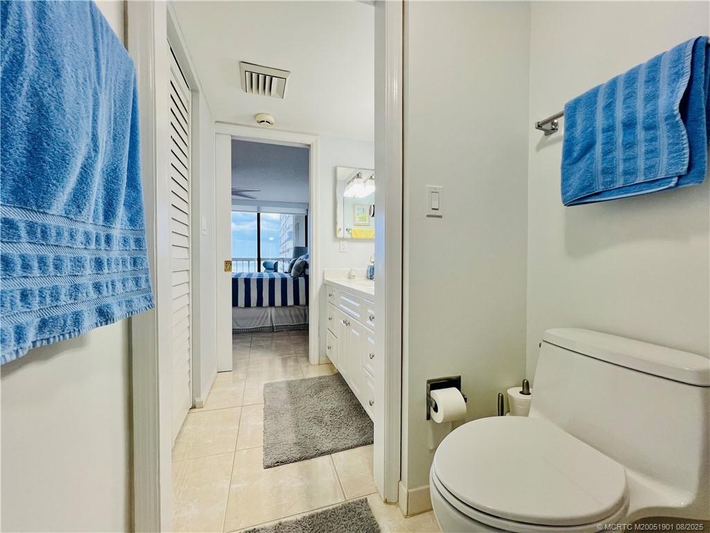 9500 South Ocean Drive, Unit 809 Jensen Beach, FL 34957 - Photo 54 of 64 a white toilet sitting next to a bathroom sink