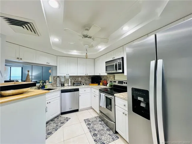 a kitchen with stainless steel appliances a refrigerator sink and microwave