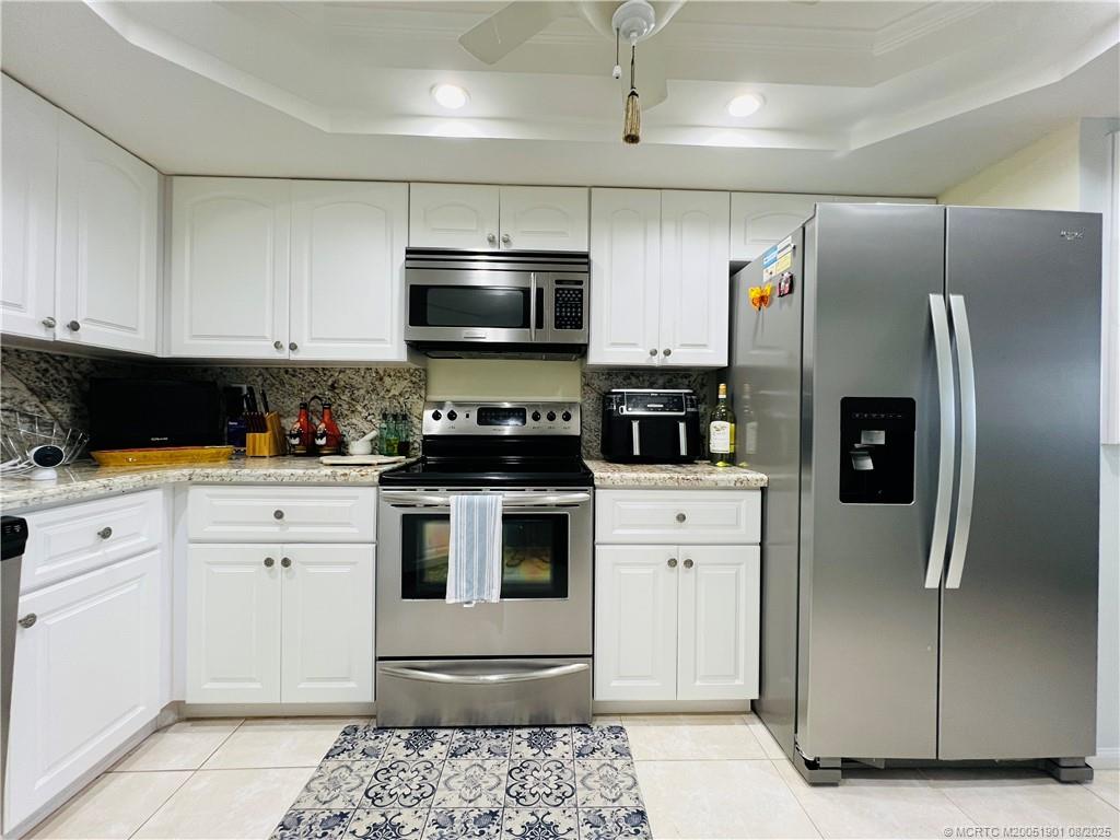 9500 South Ocean Drive, Unit 809 Jensen Beach, FL 34957 - Photo 10 of 64 a kitchen with stainless steel appliances a refrigerator sink and microwave