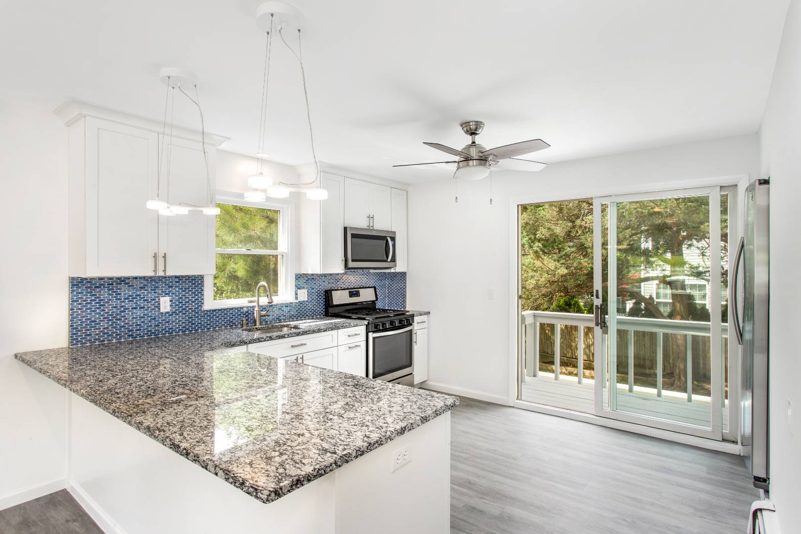 45 North Road Hampton Bays, NY 11946 - Photo 3 of 14 a kitchen with stainless steel appliances granite countertop a sink a stove top oven a counter space and cabinets