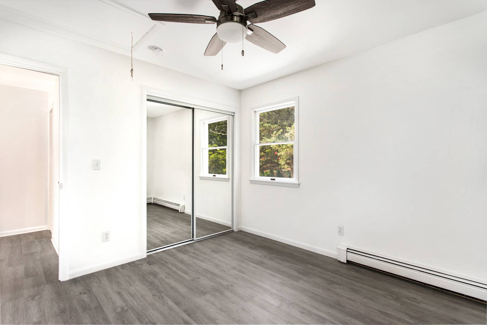 45 North Road Hampton Bays, NY 11946 - Photo 5 of 14 an empty room with wooden floor and windows
