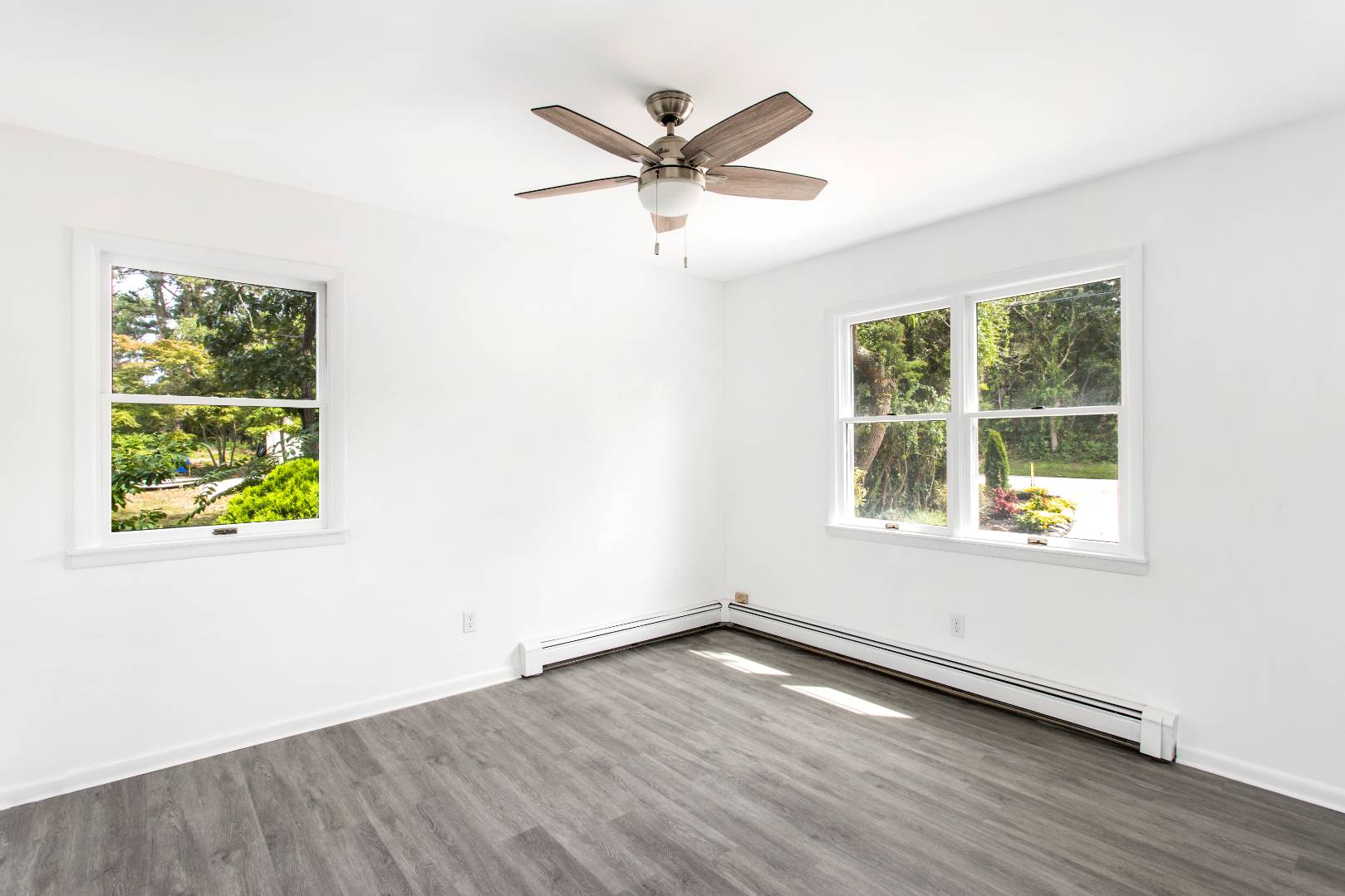 45 North Road Hampton Bays, NY 11946 - Photo 7 of 14 an empty room with window and wooden floor
