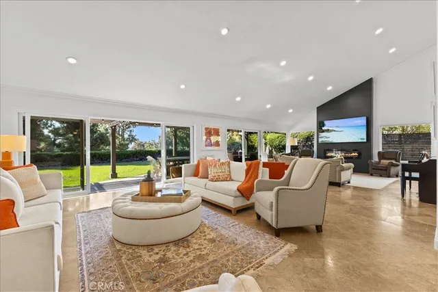 a living room with patio furniture and a large window