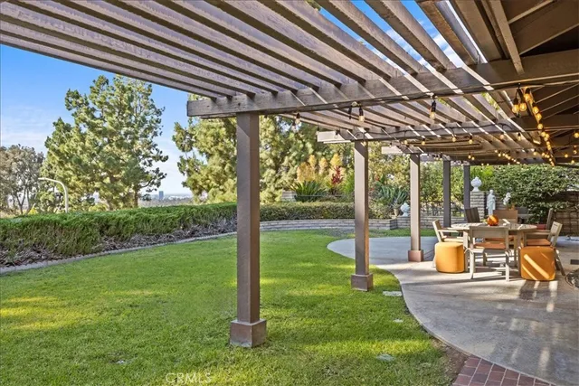 a view of a house with backyard porch and sitting area