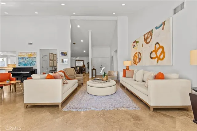 a living room with fireplace furniture and a large window