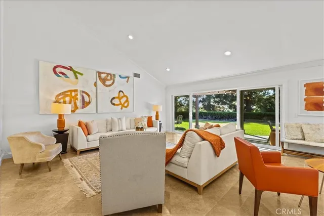 a living room with furniture fireplace and large window