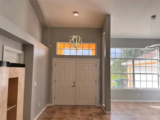 a view of empty room with window and front door